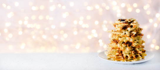 Vilnius, Lithuania. Traditional national cookies Sakotis. Copy space. Festive background, light new year and christmas bokeh.