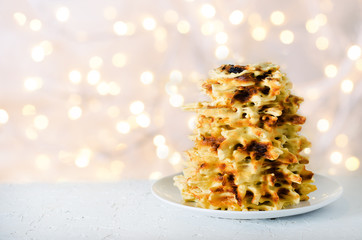 Vilnius, Lithuania. Traditional national cookies Sakotis. Copy space. Festive background, light new year and christmas bokeh.