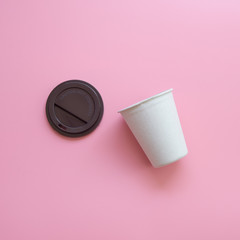 Flat lay design of Open hot coffee cup on pink pastel background.