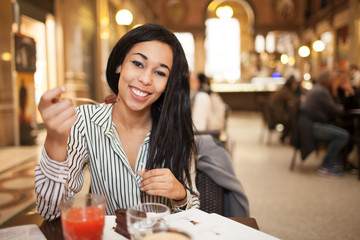 Woman Eating Cake In Coffe Shop