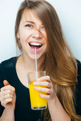 Young woman close up portrait drink orange juice. Female model happy smile.