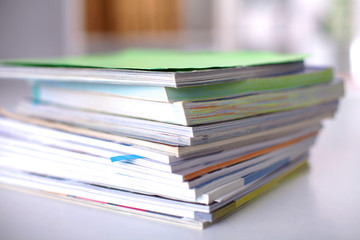 close up of stack of papers on white background
