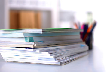 close up of stack of papers on white background