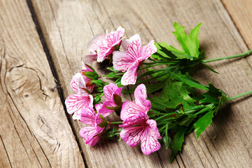 Fototapeta na wymiar fresh flowers on a wooden table background