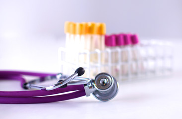 stethoscope near medical tubes on white background