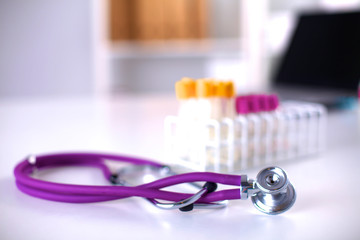 stethoscope near medical tubes on white background