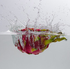 Dragon fruit falling water splash