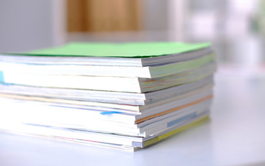 close up of stack of papers on white background