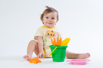 Cute baby with bucket and spade isolated on white background