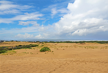Fototapeta na wymiar Dramatc clouds and sand dunes viewed from Jockeys Ridge State Park, Nags Head, NC