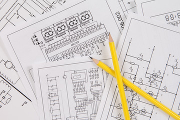 Two pencil and background of printed electrical drawings