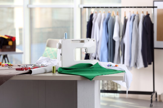 Fashion designer workplace with sewing machine on table
