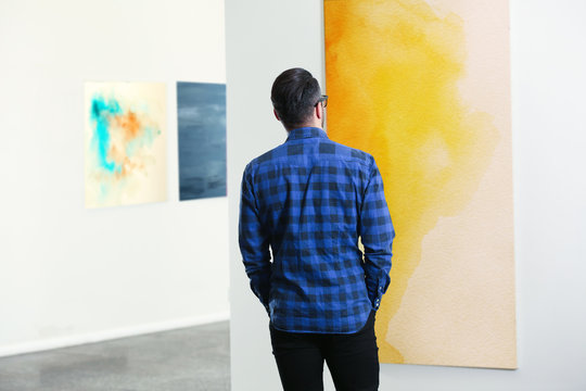Young man in modern art gallery