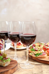 Wine with tasty bruschetta served on table
