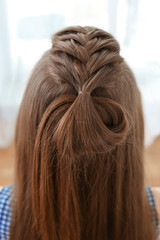 Young beautiful woman with nice braid hairstyle, closeup