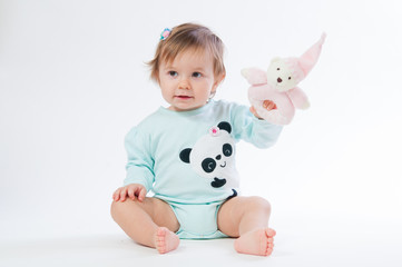 Portrait of a smiling child with a toy bear, isolated on a white background