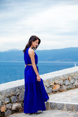 photo of beautiful young woman standing on the stairs  in Greece