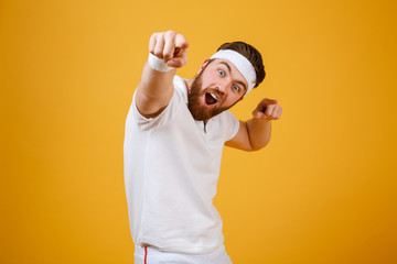 Happy screaming sportsman pointing at camera