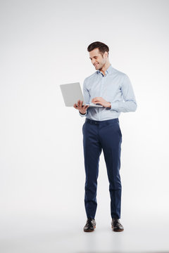 Vertical image of business man using laptop