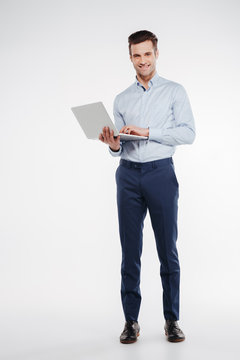 Vertical image of Smiling business man with laptop