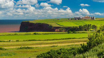 The pastoral landscape and rugged cliffs of western Prince Edward Island, Canada.