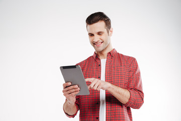Smiling man using tablet computer