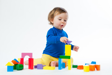 Little child playing with dices isolated on white background