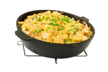 potatoes cooked in a frying pan with cheese, on a white background