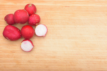 Red fresh radish on wooden kitchen board