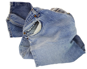 Isolated pair of faded denim jeans in a jumble.