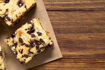 Cherry blondie or blond brownie cake baked with white and dark chocolate, photographed overhead...