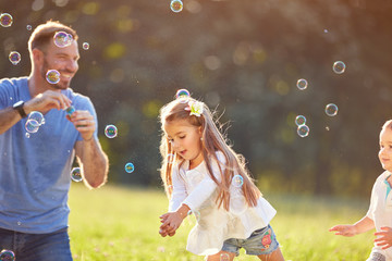 Girl catch soap bubbles outside