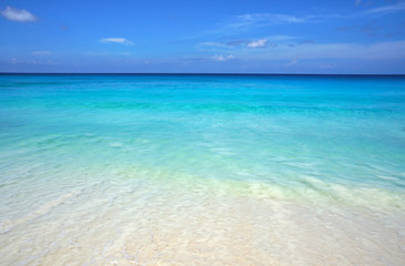 Scenic seascape of azure transparent ocean water and blue sky. Tropical beach with white sand....