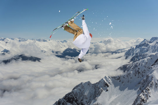 Flying skier on mountains. Extreme winter sport.