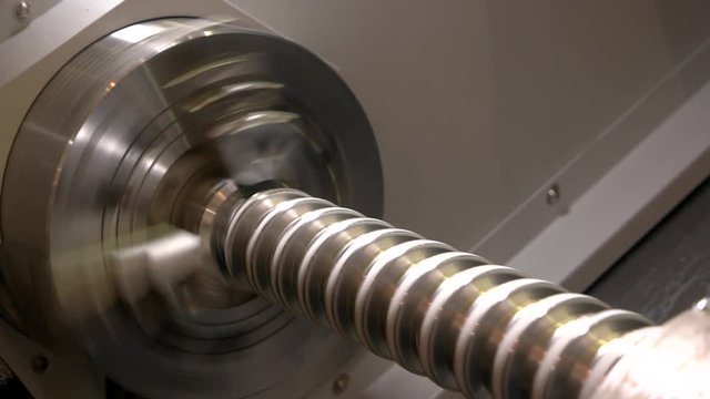 Turning lathe in action, closeup. Metal mechanism with a spiral.