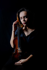 Beautiful young woman playing violin