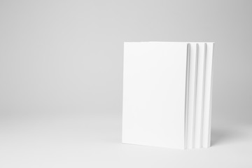 Real paperback white books on a gray background