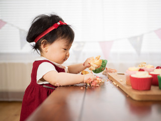 baby girl eating cup cake