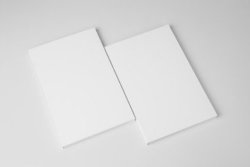 Real paperback white books on a gray background