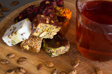 Turkish delight with tea on a wooden background