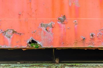 Part of an old railway wagon with flaking red paint - obrazy, fototapety, plakaty