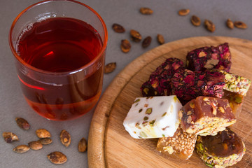 Turkish delight with tea on a wooden background