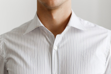 White shirt on the businessman. Unbuttoned collar. Beautiful elegant shirt. Close up view