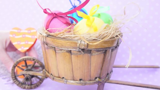Easter eggs in a cart, behind put orange heart  clothespin holder decorative