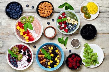 Fototapeta na wymiar Variation of healthy smoothie breakfast bowls with berries, fruits and nuts