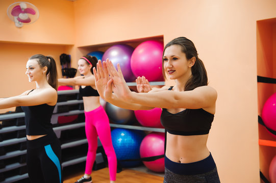 Beautiful women exercising aerobics in fitness club