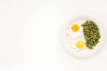 Healthy breakfast. Fried eggs, green beans on white background. Flat lay