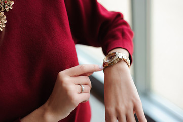 beautiful woman looks at the clock