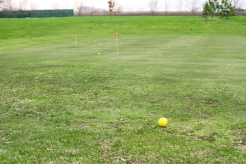 Yellow golf ball on course