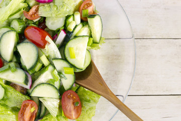 Homemade Vegetable salat on light wood background, top view